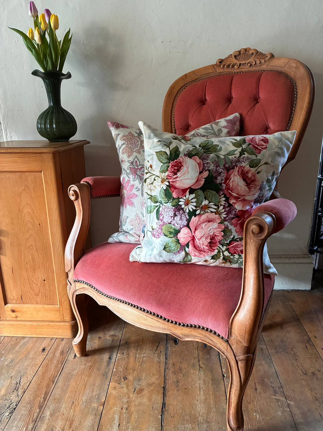 Victorian Style Button Back Armchair with floral pillows in a cozy interior setting.