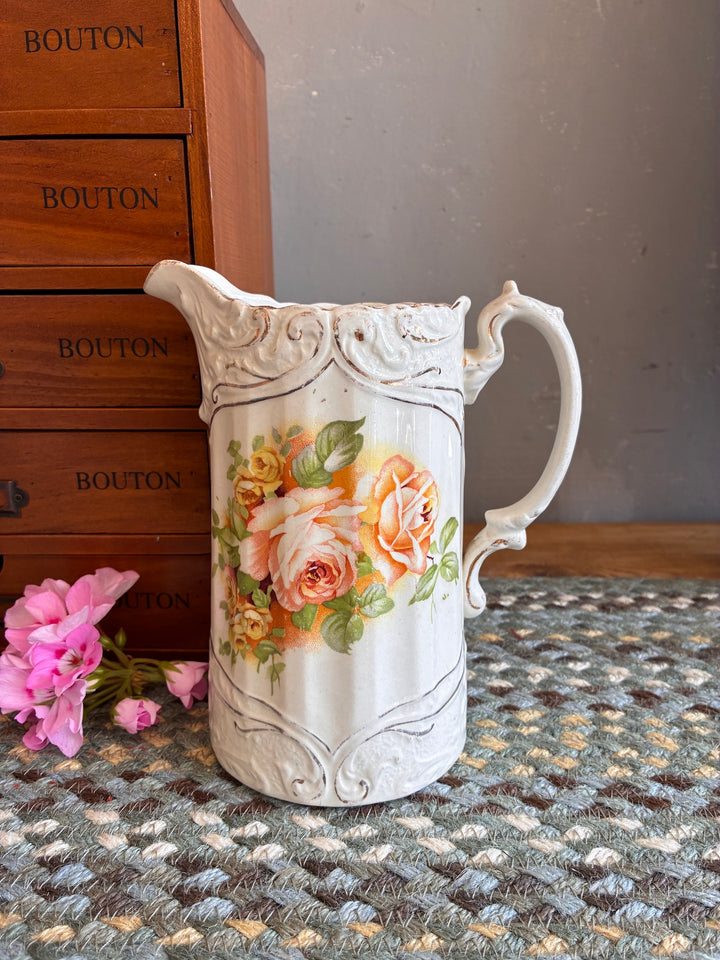 Small Edwardian China Jug with Yellow Flowers on a textured surface, featuring peach and yellow roses, vintage style.