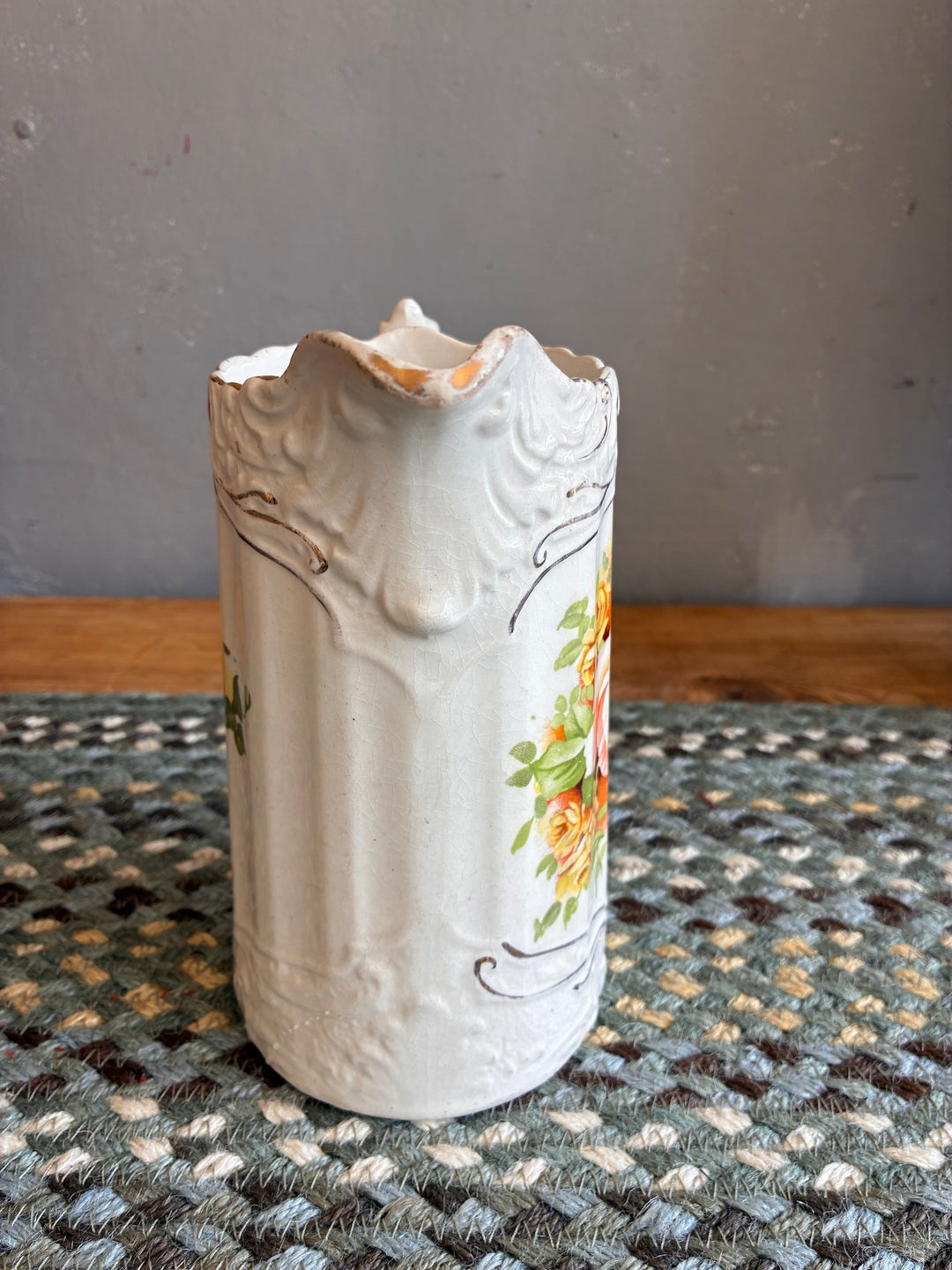 Small Edwardian China Jug with Yellow Flowers displayed on a woven mat, showcasing intricate floral design and vintage character.