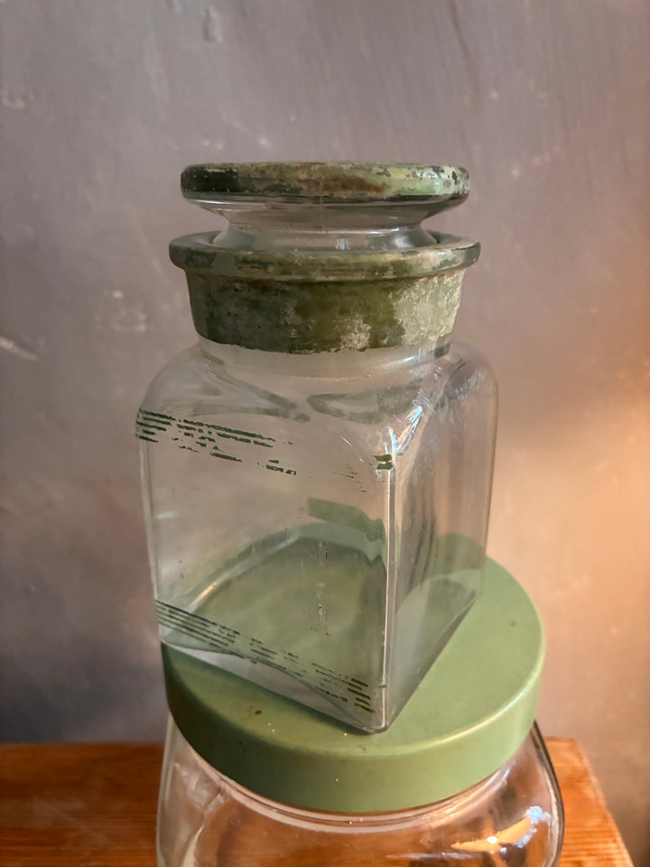 Vintage 1930s Glass Bathroom Set featuring a glass bottle with period-perfect green lettering and authentic stopper.