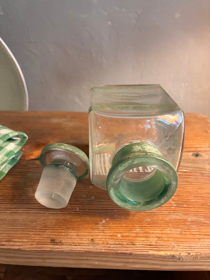 Vintage 1930s Glass Bathroom Set with glass bottles and stoppers in vintage green.