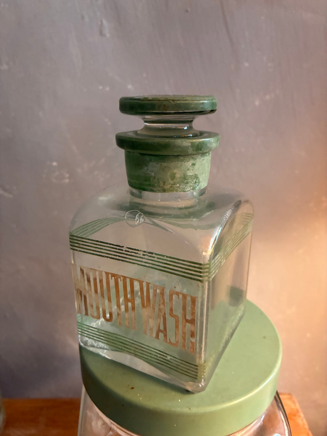 Vintage 1930s Glass Bathroom Set Mouth Wash bottle with green lettering and glass stopper.