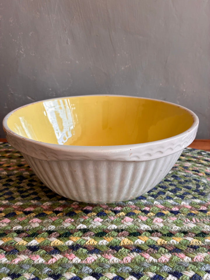 Vintage yellow and white TG Green Easimix bowl with ribbed exterior, perfect for kitchen use and decor, sourced from Devon.