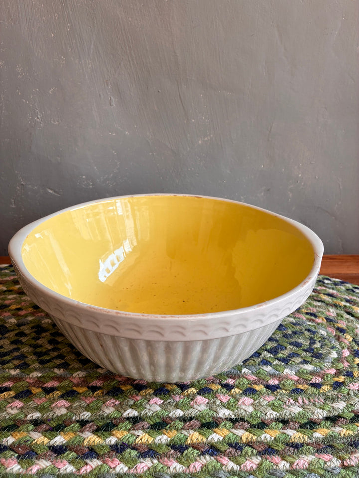 Vintage Yellow and White TG Green Easimix Bowl with ribbed exterior, perfect for kitchen decor and fruit display.