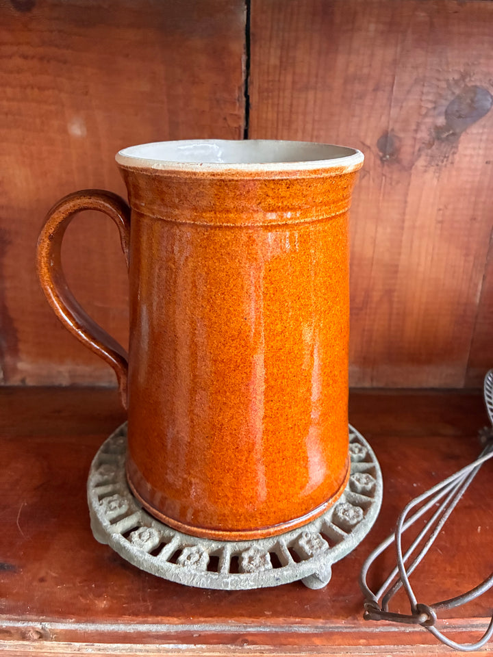 Antique French Earthenware Milk Pitcher in a rustic orange glaze, perfect for farmhouse decor.