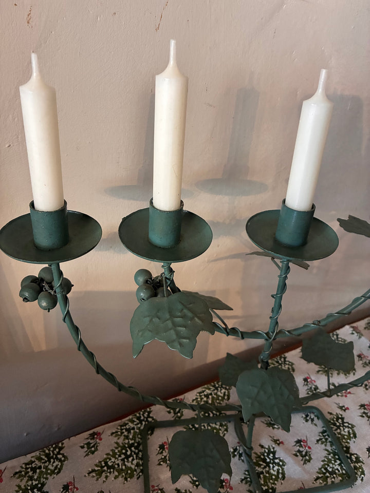 Vintage Green Five Arm Candelabra featuring intricate metal vines and candle holders with white candles.