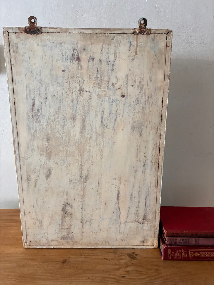 Vintage Mirrored Bathroom Cabinet back view showing weathered texture and old hooks for wall mounting.