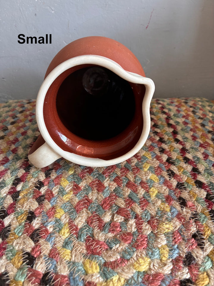 Vintage Slipware Terracotta Jug - North Devon, viewed from above, showcasing the cream slipware rim and terracotta body.