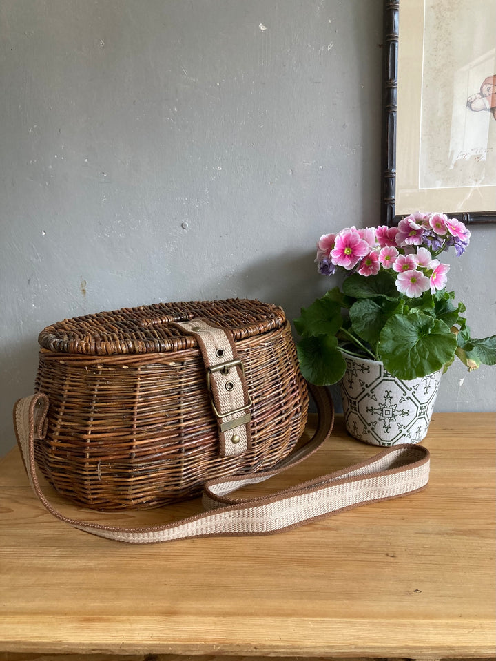 Wicker fishing creel with a carrying strap, perfect for storage or outdoor adventures, sourced from Source for the Goose Devon.