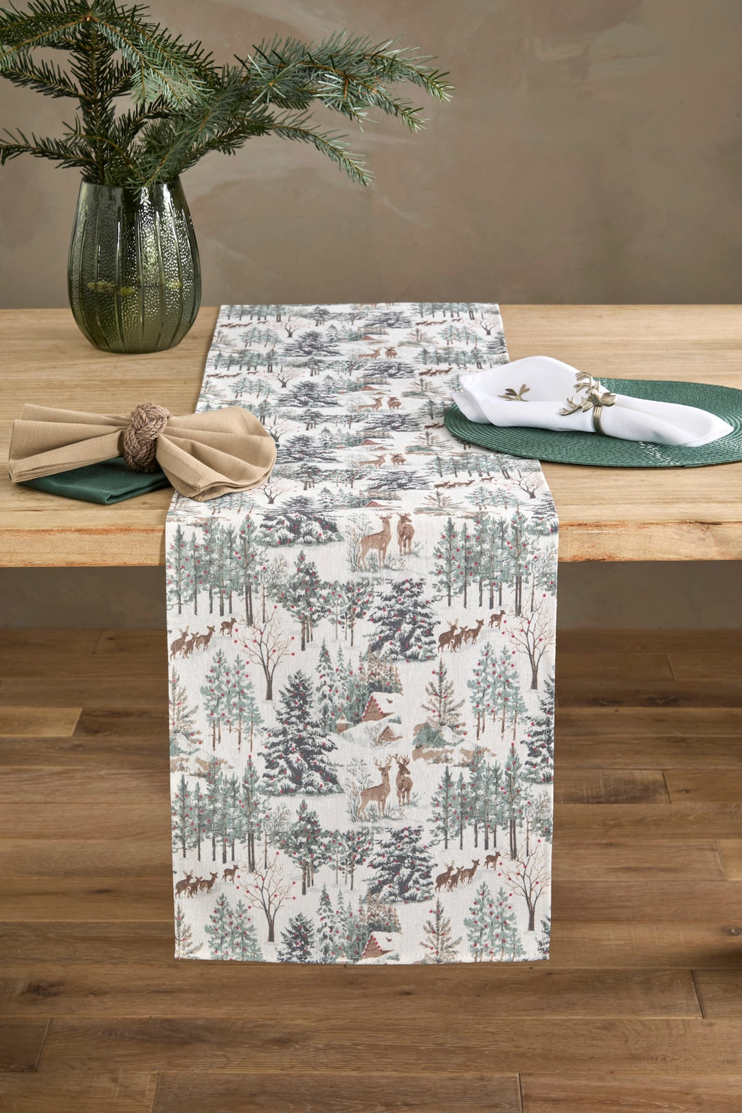 Winter Scene Table Runner - Longer Length displayed on a rustic wooden table, enhancing the festive decor with pine trees and deer.