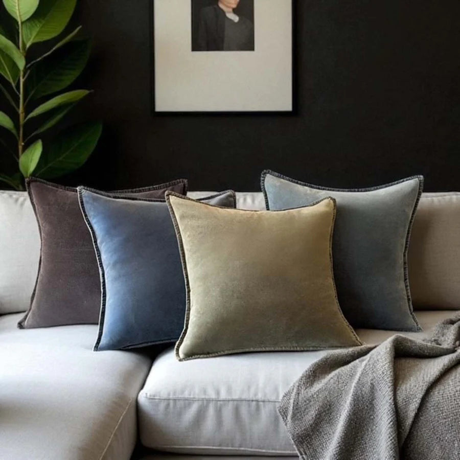 Stonewashed velvet cushions in earthy tones on a couch, showcasing luxury and comfort from Source for the Goose, Devon.