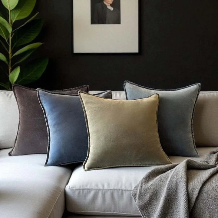 Stonewashed velvet cushions in earthy tones on a couch, showcasing luxury and comfort from Source for the Goose, Devon.