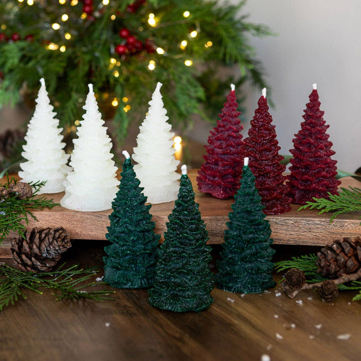 Pintail Candles - Christmas Tree Forest Christmas Tree Candle in festive scents, showcasing tree-shaped candles on wooden table.