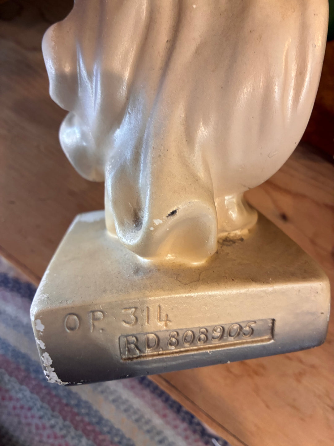 Bottom view of an Antique Art Deco Chalkware Lady Figurine showcasing markings and details.