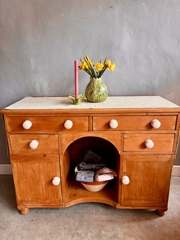 Small Antique Pine Kneehole Desk with white porcelain knobs and rustic floral decor.