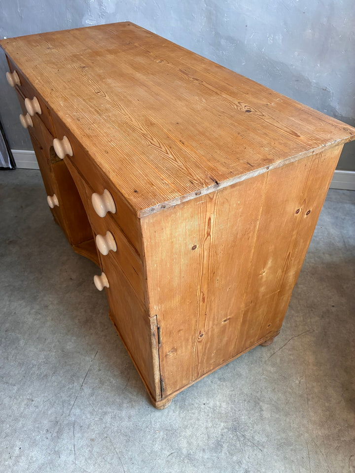 Small Antique Pine Kneehole Desk with white porcelain knobs and rustic wood finish.