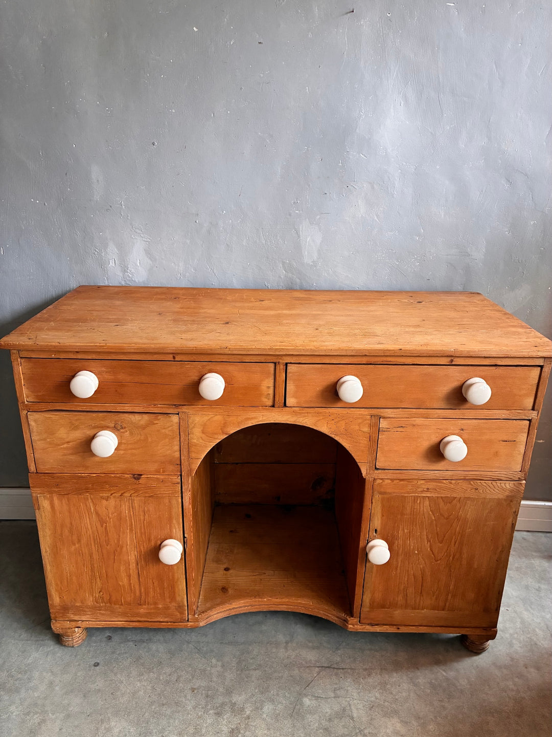 Small Antique Pine Kneehole Desk with white porcelain knobs and rustic charm from Source for the Goose Devon.