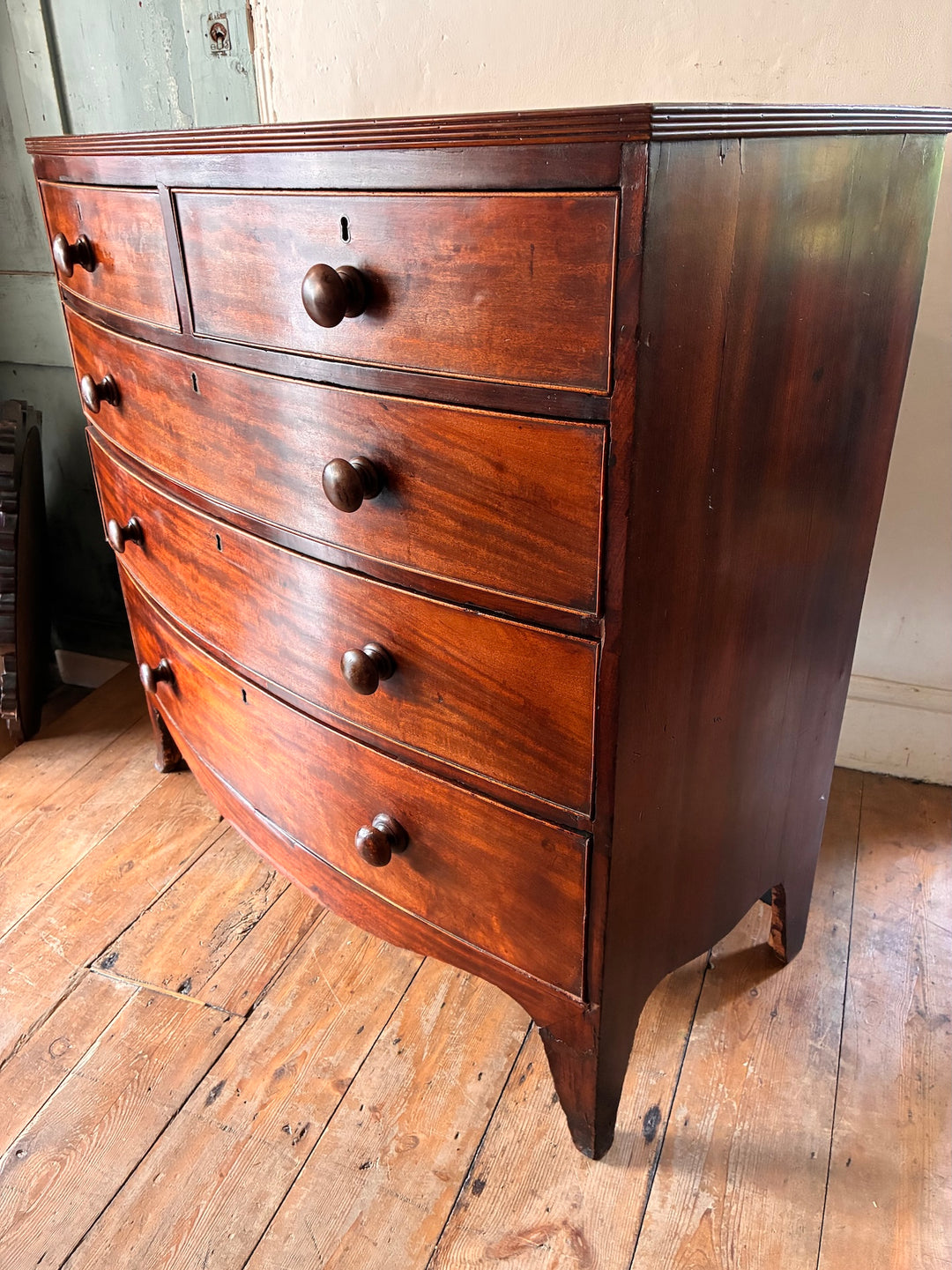 Antique Mahogany Bow Front Chest of Drawers featuring graceful design and original knobs, perfect for vintage home decor in Devon.