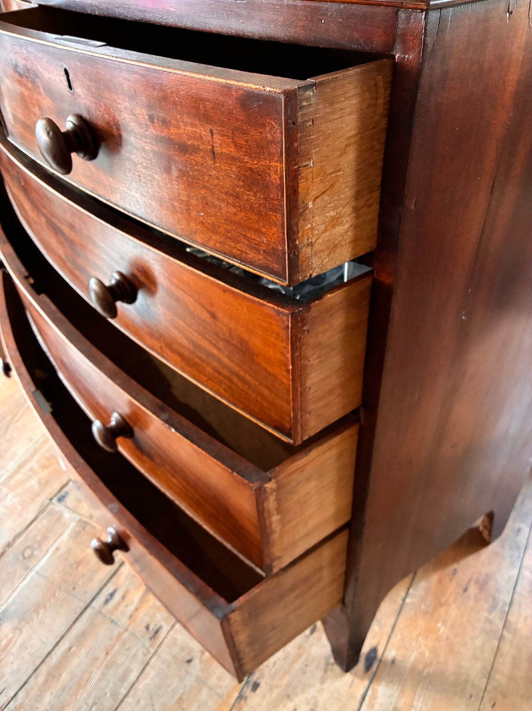 Antique Mahogany Bow Front Chest of Drawers showing elegant curved design and original wooden knobs.