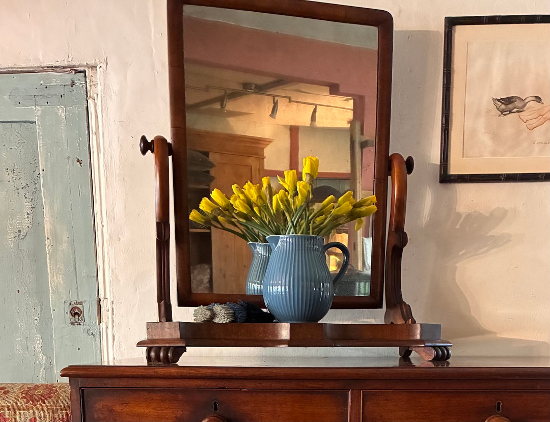 Antique Dressing Table Mirror showcasing a blue vase with yellow flowers on a wooden dresser.