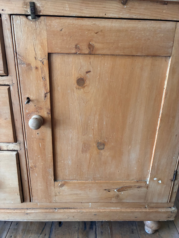 Small Victorian Pine Dresser with Galleried Back showing cupboard door and rustic wooden texture.