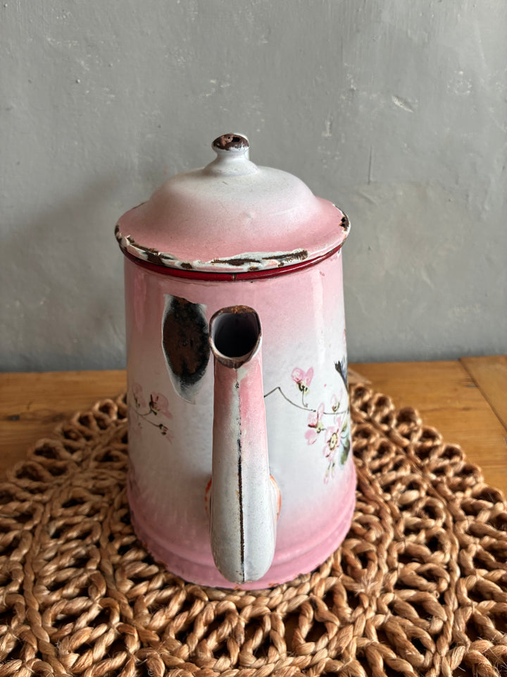 Vintage pink and white French enamel coffee pot with hand-painted bird design, distressed finish, perfect for retro decor.