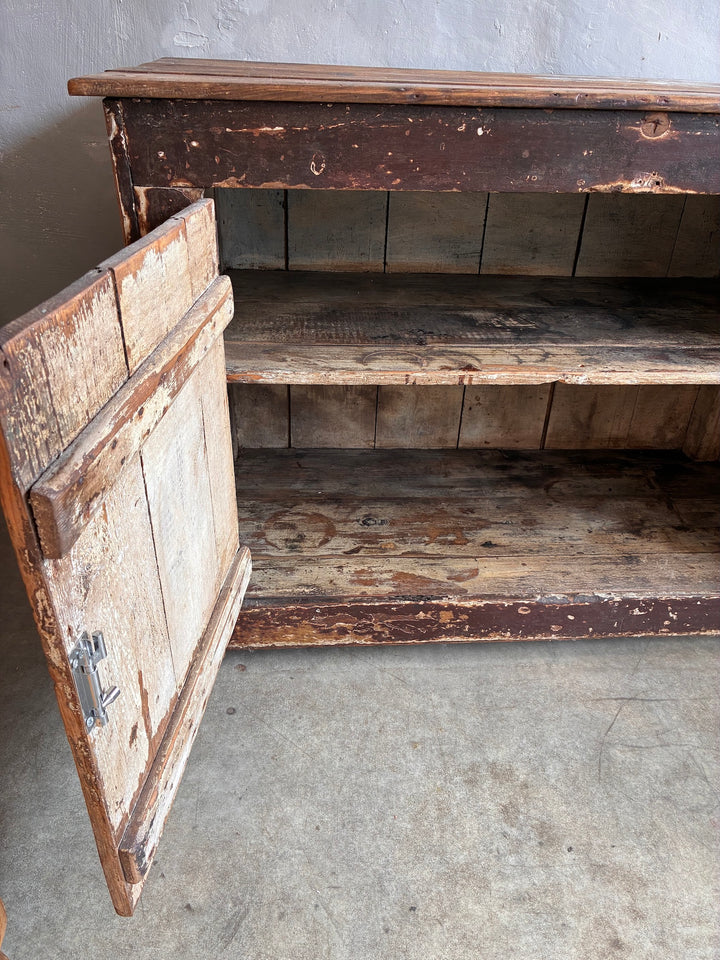 Primitive Antique Pine Wooden Sideboard showcasing an authentic distressed finish with an open door revealing storage space.