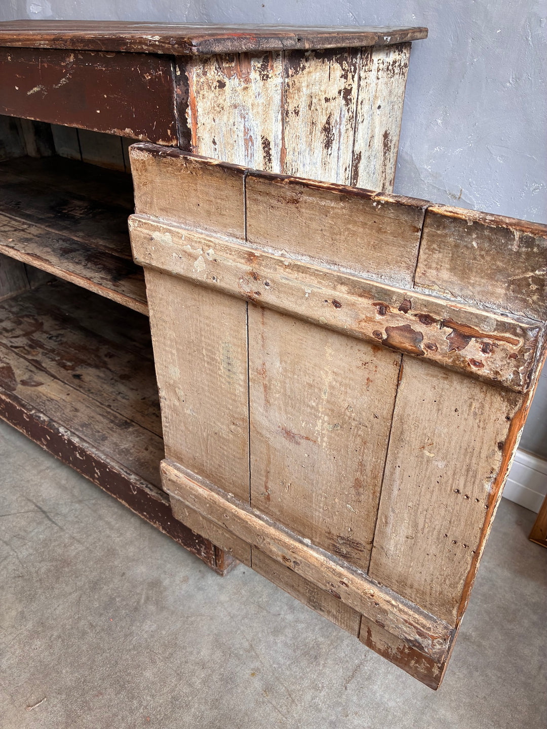Close-up of the distressed finish on the Primitive Antique Pine Wooden Sideboard from Source for the Goose Devon.
