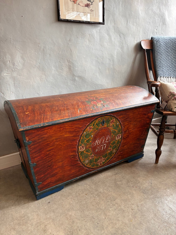 Antique Danish Dowry Chest with floral hand-painted design, blue iron handles, and dated 1877. Source for the Goose, Devon.