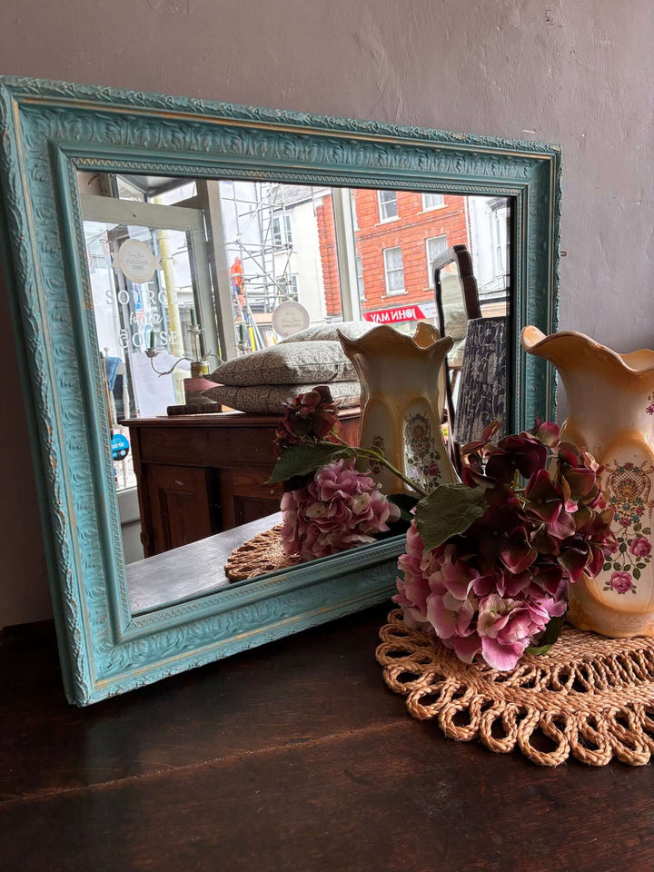 Vintage Rectangular Mirror in Blue from Source for the Goose, adorned with flowers and a decorative vase.