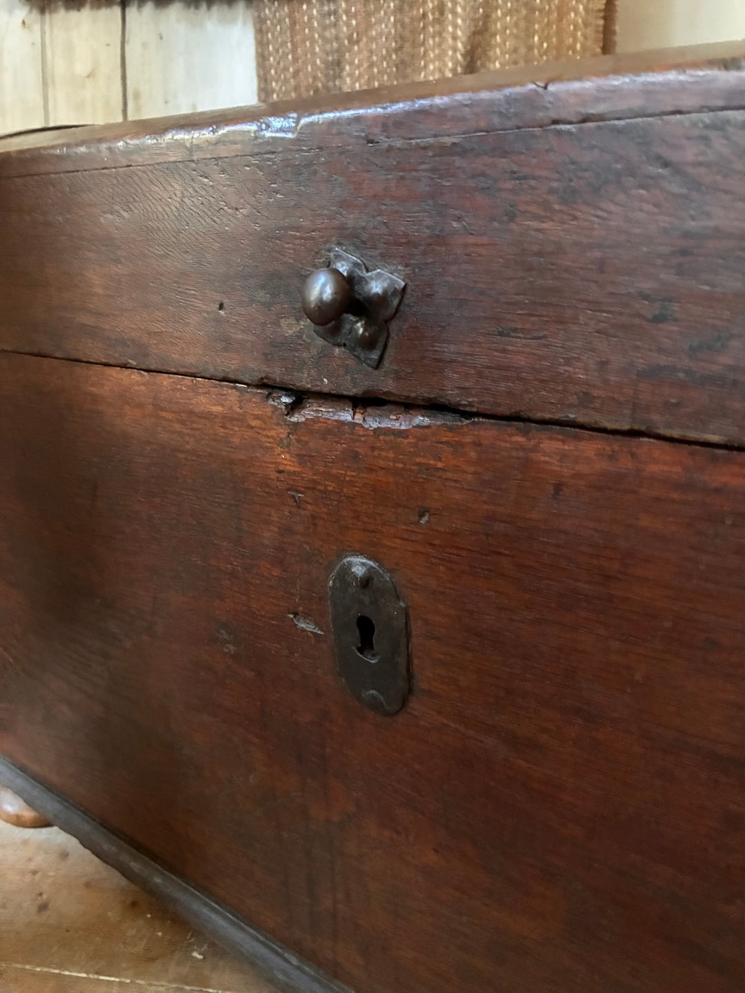 Close-up of the lock and knob on the Antique Wooden Dome Top Trunk, showcasing its rustic charm.