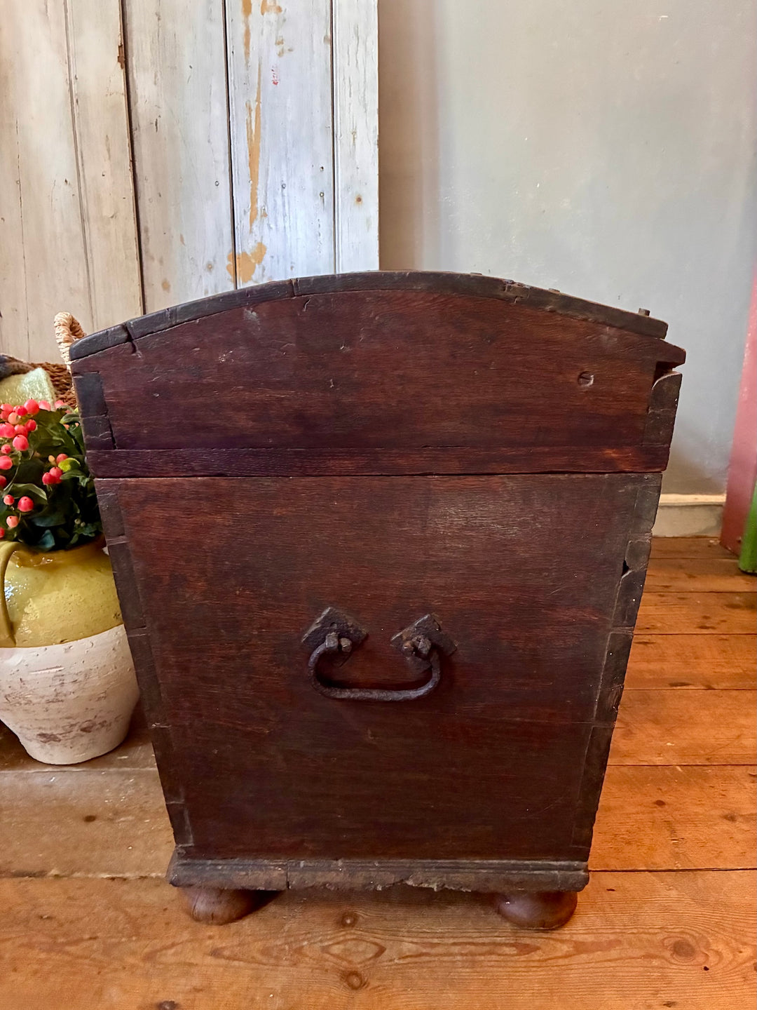 Antique Wooden Dome Top Trunk with a rustic wooden finish and iron handle, showcasing vintage charm.