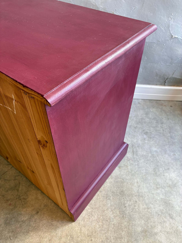 Hand-painted aubergine folk art style cupboard by Source for the Goose, with a rustic pine base and compact storage.