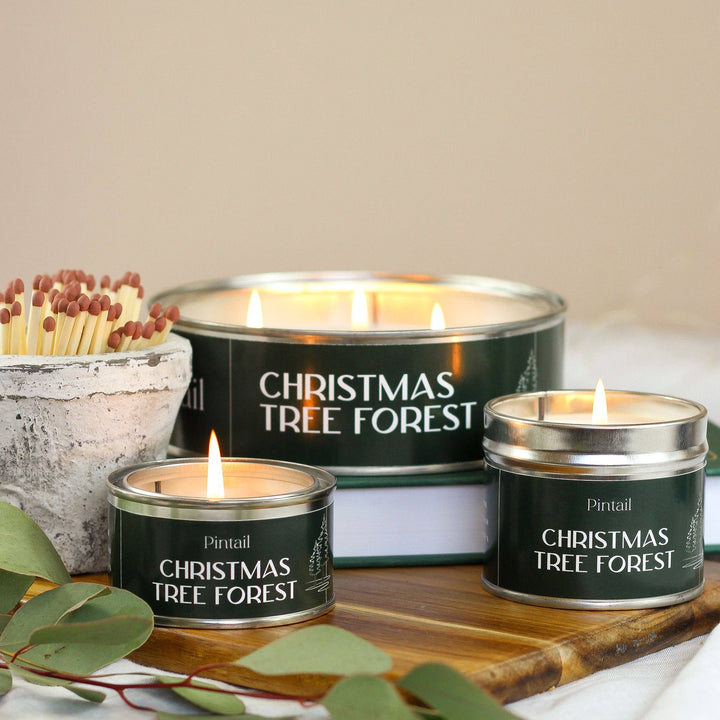 Pintail Candles Christmas Tree Forest Triple Wick candle set with matches in a rustic setting.