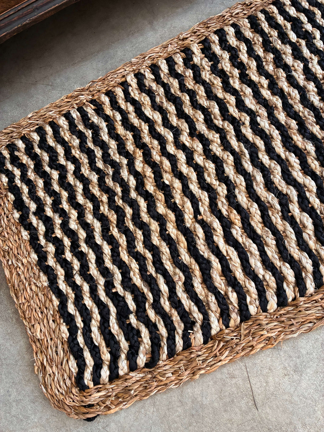 Stylish jute doormat in black and natural tones, perfect for welcoming guests, from Source for the Goose, Devon.