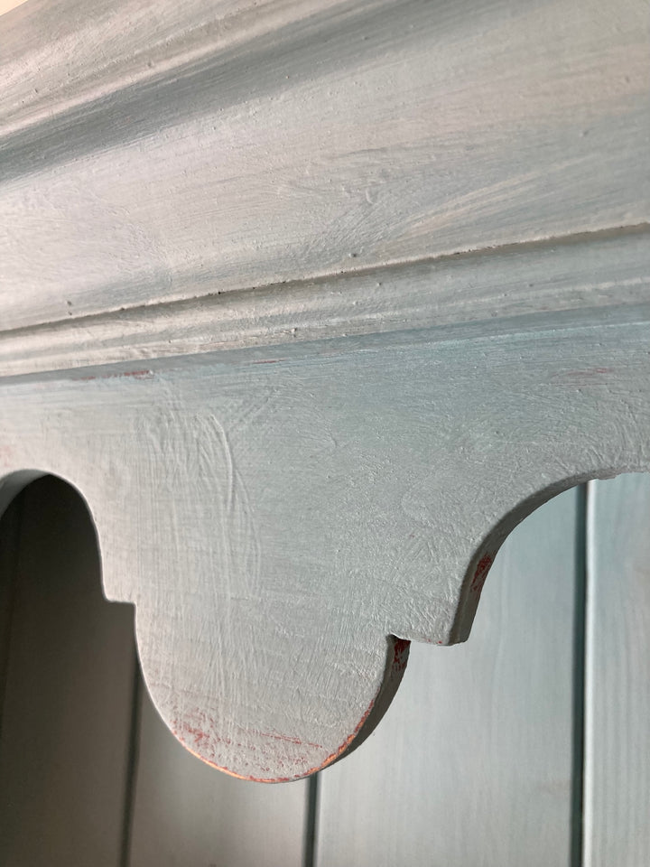 Detailed view of the vintage blue painted dresser showcasing intricate scalloped edge design, adding charm and character.