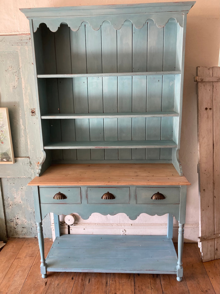 Vintage blue painted dresser with three shelves and three drawers, adding charm to small spaces. Source for the Goose, Devon.