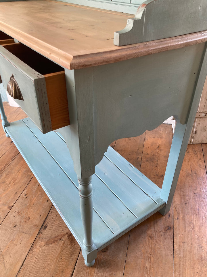 Vintage blue painted dresser featuring a wooden top, open drawers, and a chic design perfect for small spaces. Source for the Goose, Devon.