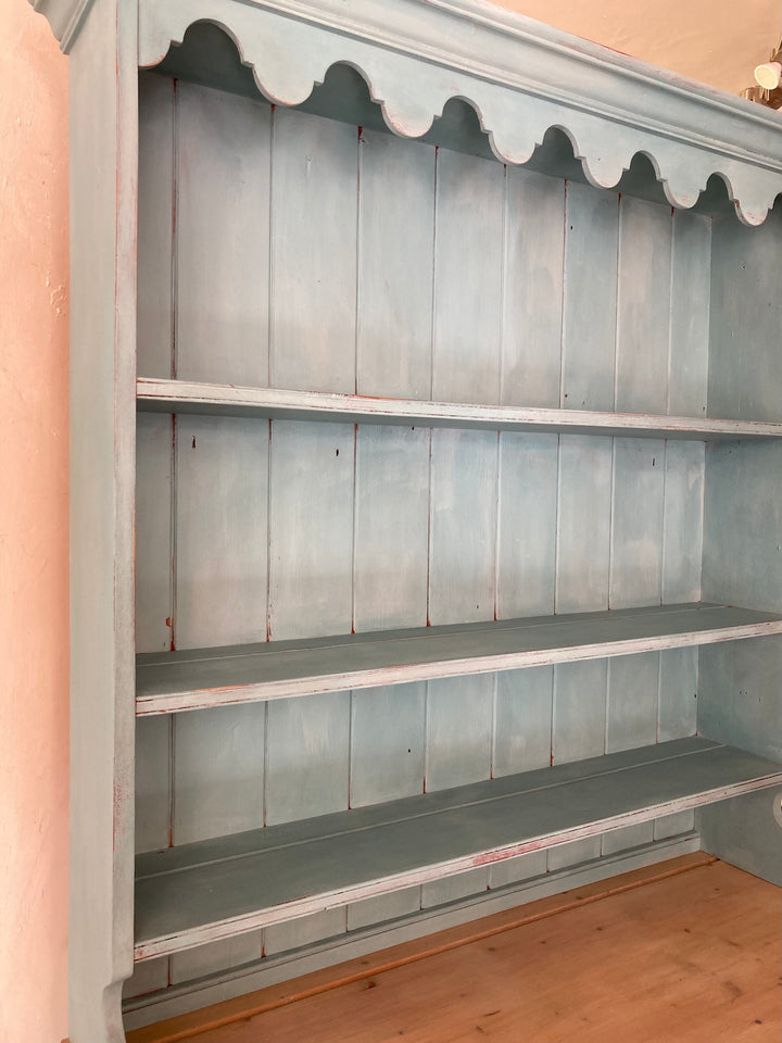 Vintage blue painted dresser with three spacious shelves, showcasing a charming chippy paint effect. Source for the Goose, Devon.