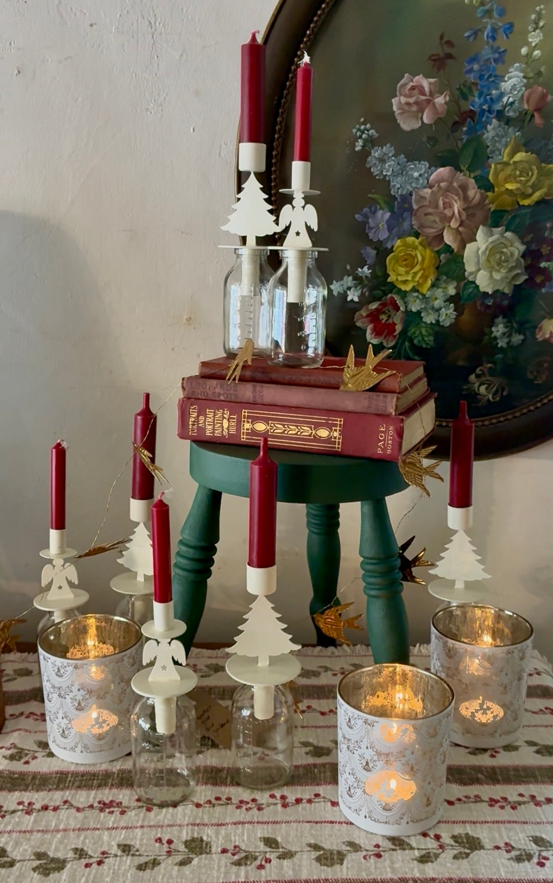 Christmas display at Source for the Goose featuring angel and tree bottle candleholder topped with seasonal red candles