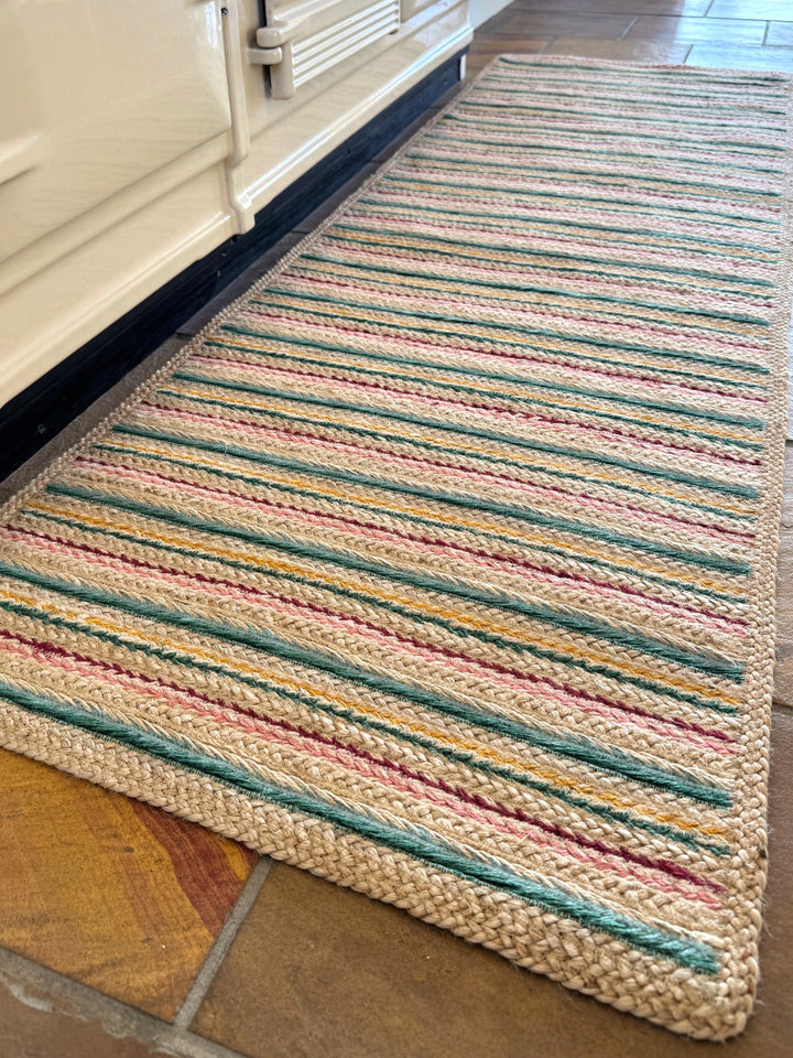 Ikat Stripe Organic Jute Braided Rug, a jute runner featuring colorful stripes, ideal for kitchens and high-traffic areas.