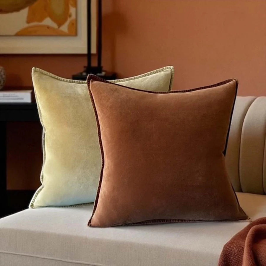 Stonewashed velvet cushions in earthy shades of caramel and green, enhancing cozy home decor. Source for the Goose, Devon.