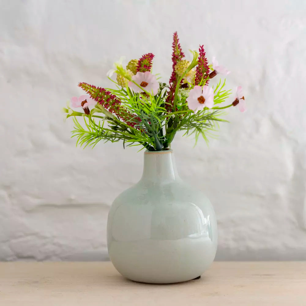 Dainty Ceramic Bud Vase- Various Colours with flowers in a soft grey color on a wooden table.