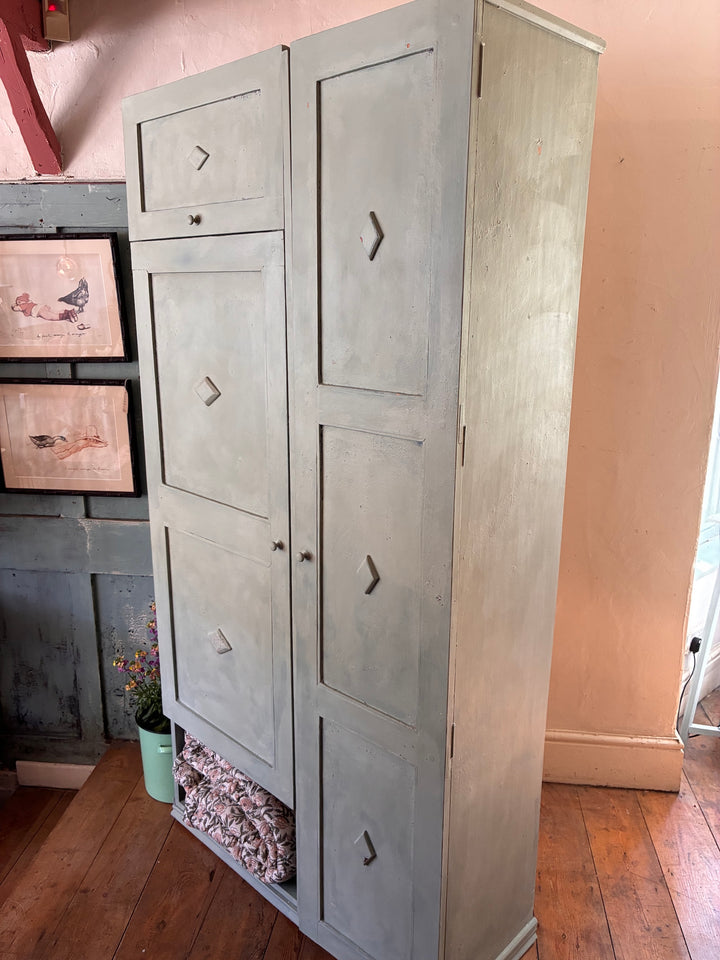 Tall vintage green wooden cupboard with chippy paint, showcasing ample storage and rustic charm from Source for the Goose, Devon.
