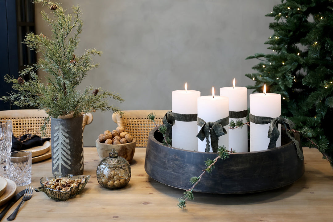 Elegant Christmas table setting with candles, festive greenery, and seasonal décor from Source for the Goose, Devon.