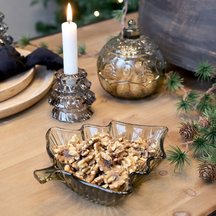 Dainty Christmas Tree Glass Bowl filled with nuts, elegantly set on a festive coffee table with seasonal decor.