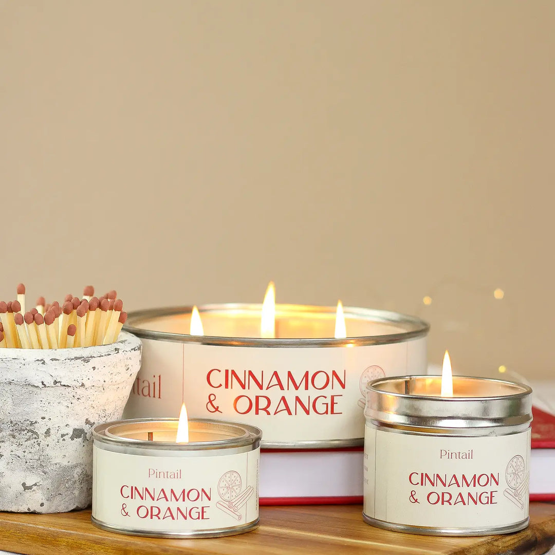Triple Wick Cinnamon & Orange Pintail Candle from Source for the Goose, Devon, glowing on a cozy table setting.