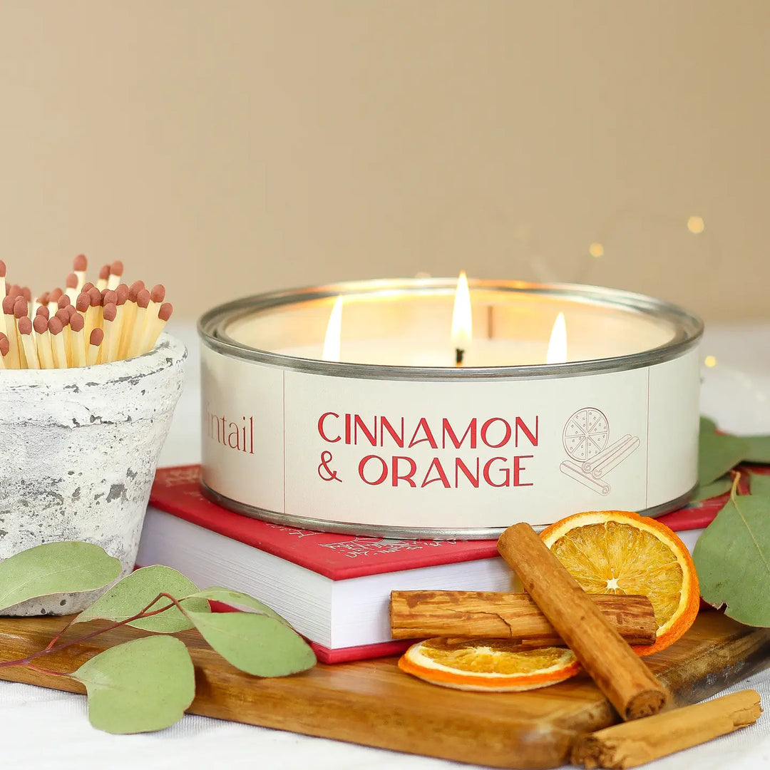 Triple Wick Cinnamon and Orange Pintail Candle by Source for the Goose, Devon, on a wooden tray with matches and spices.
