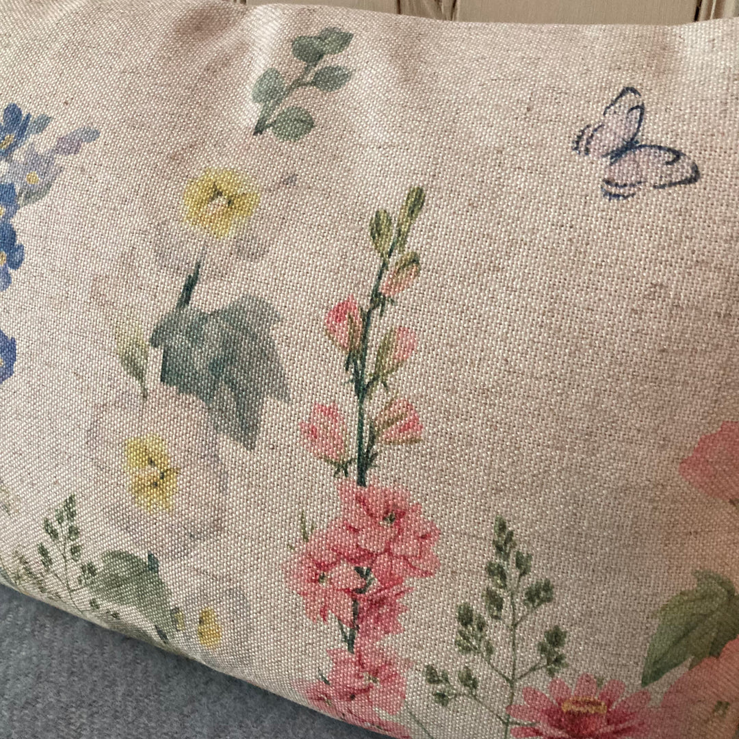 hollyhocks and other English country garden flowers on cushion