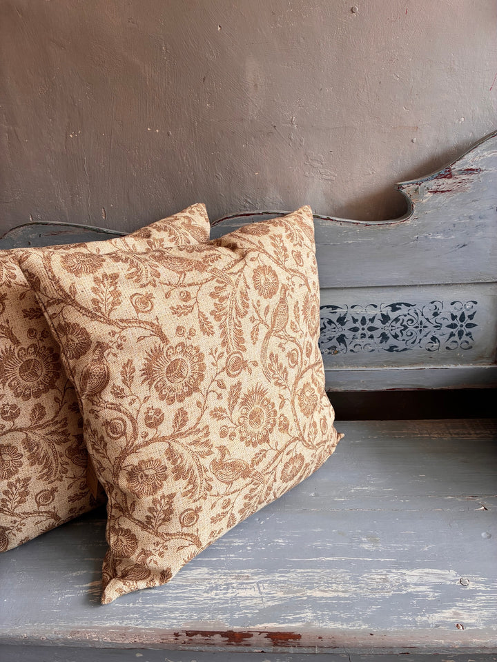 Patterned pillows on a rustic wooden surface